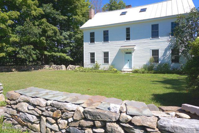 519 Main Road Monterey, MA 01245 - Photo 3 of 28 a front view of a house with garden