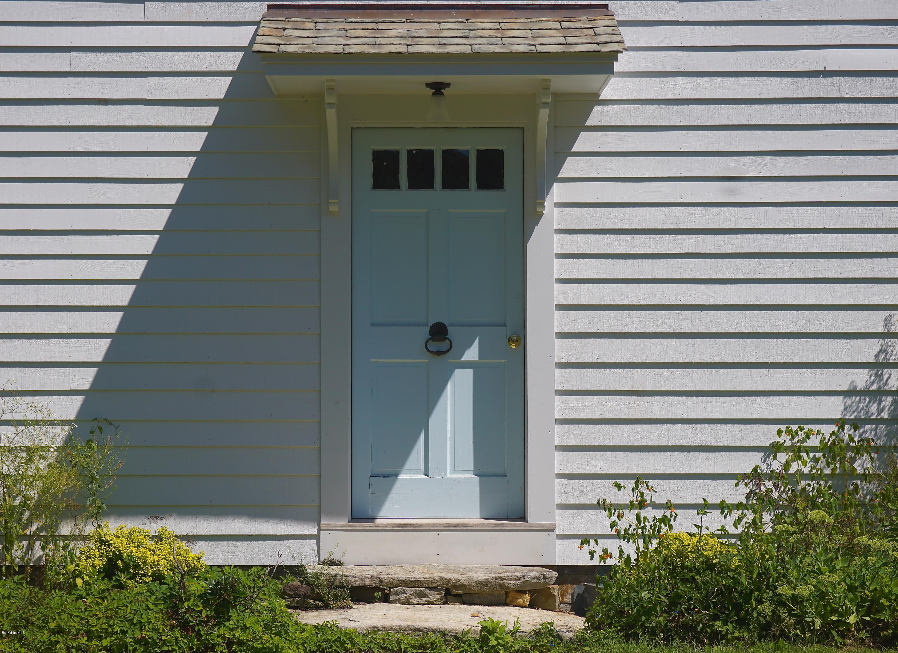 519 Main Road Monterey, MA 01245 - Photo 4 of 28 a front view of a house with plants