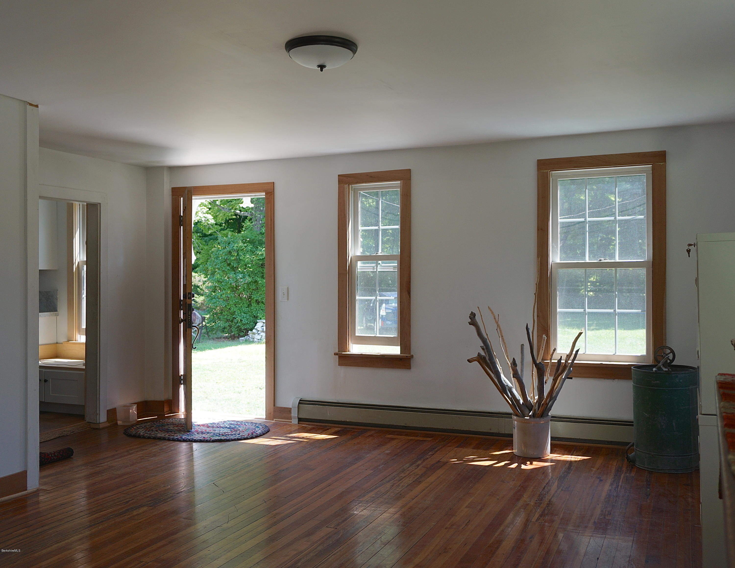 519 Main Road Monterey, MA 01245 - Photo 7 of 28 a view of an empty room with a window and wooden floor