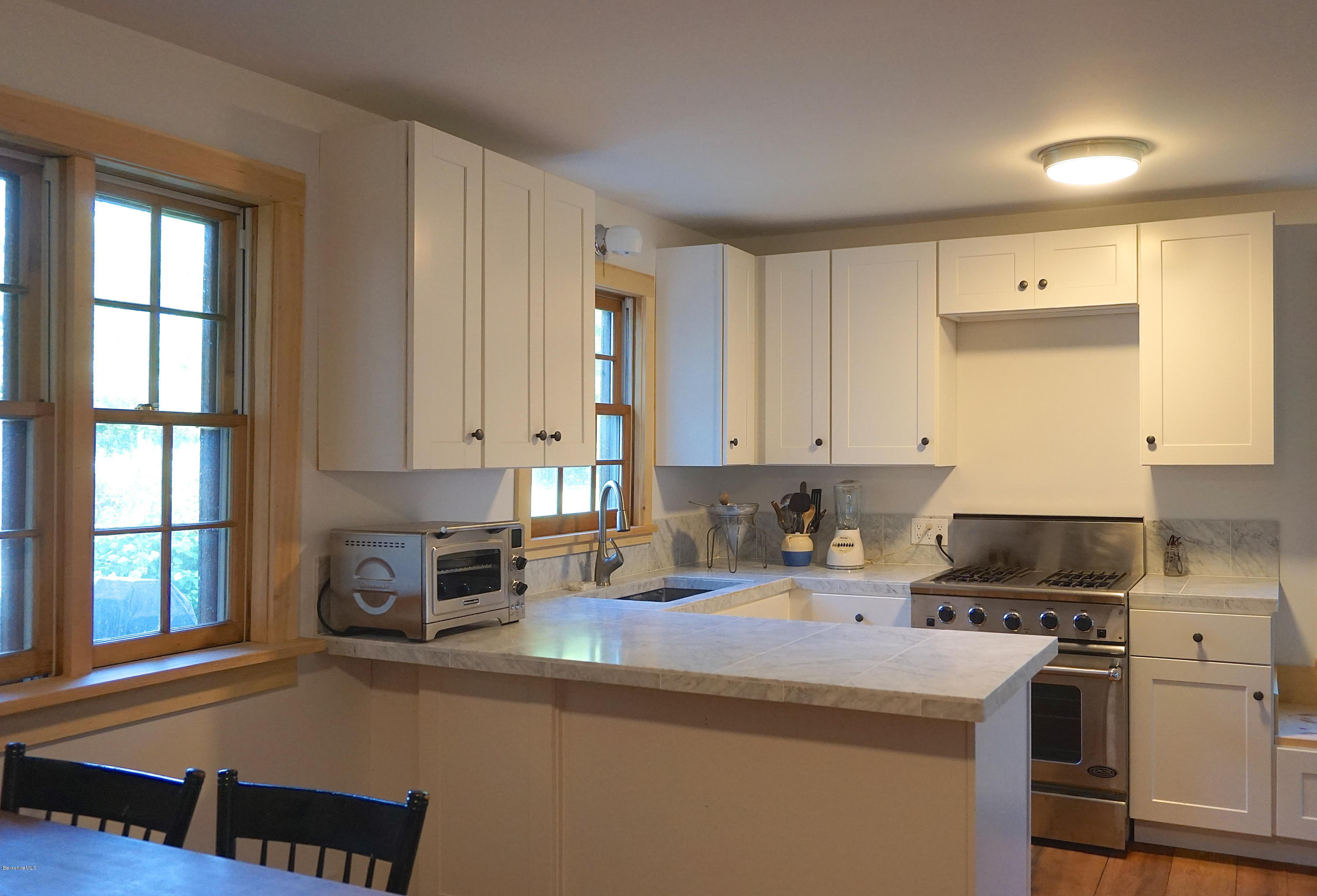519 Main Road Monterey, MA 01245 - Photo 9 of 28 a kitchen with a sink a stove and a window