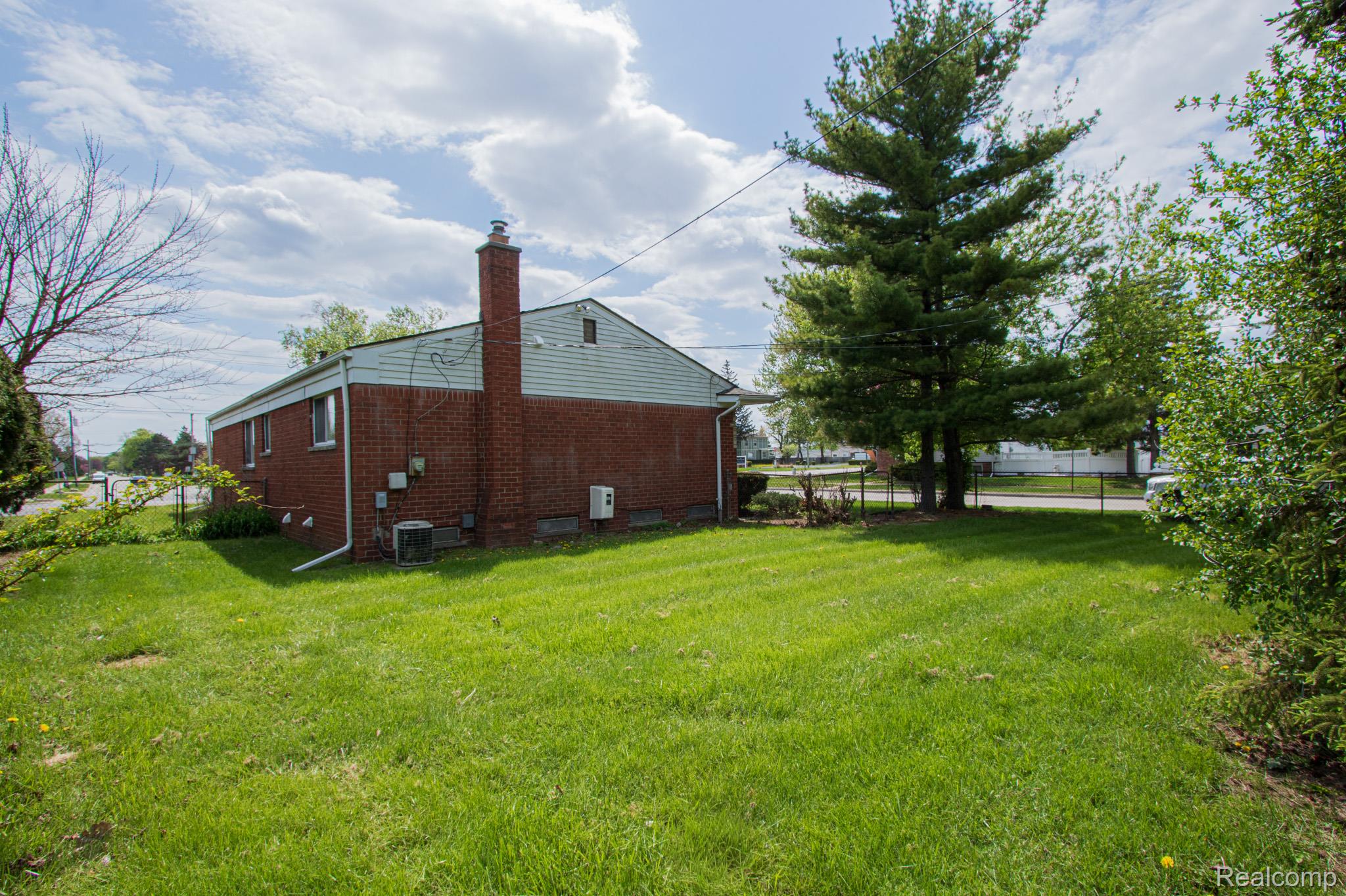 31000 Fall Fraser, MI 48026 - Photo 4 of 28 View of property exterior with a chimney and brick siding