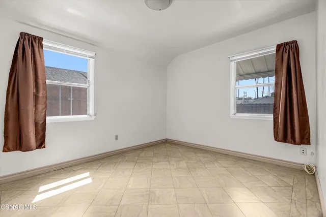 a view of an empty room with windows