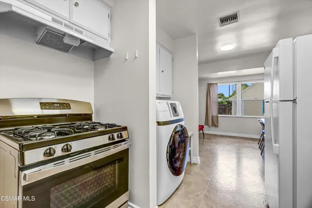 a kitchen with a stove and a refrigerator