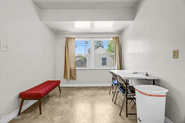 a view of a dining room with furniture a rug and wooden floor