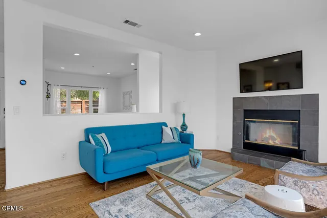 a living room with furniture and kitchen view