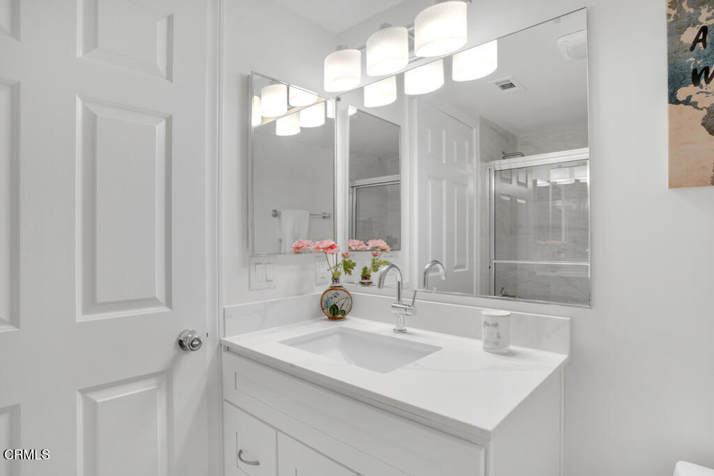 1300 Blue Hill Road Los Angeles, CA 90041 - Photo 38 of 54 a bathroom with a sink a mirror and a shower