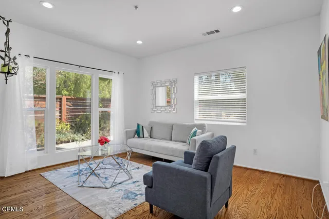 a living room with furniture and wooden floor