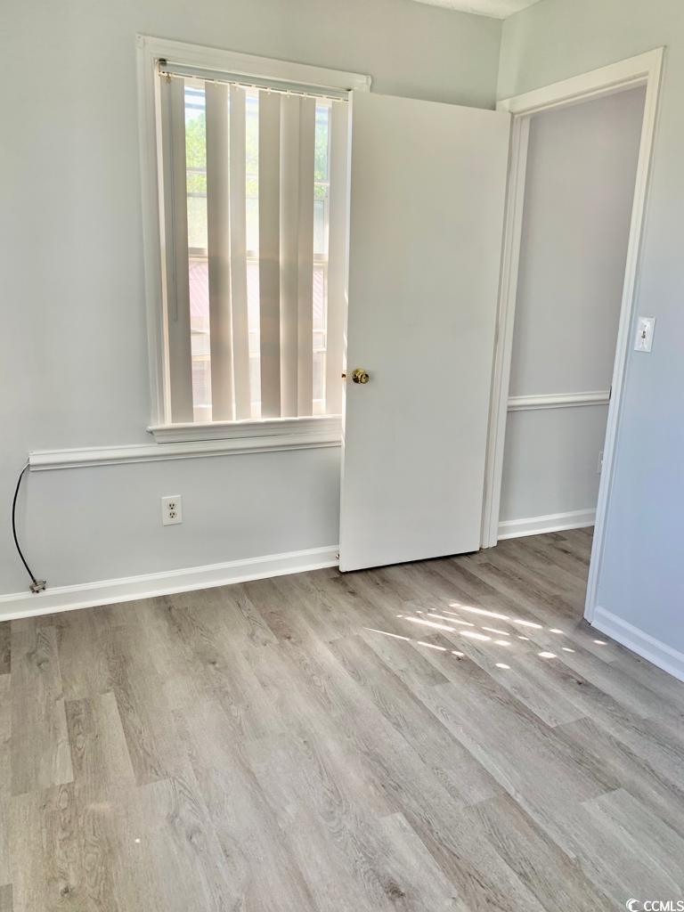 105 South Merriman Road, Unit 1 Georgetown, SC 29440 - Photo 6 of 22 Unfurnished room featuring light wood-style flooring