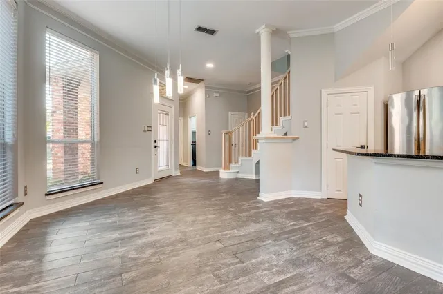a view of a kitchen with a refrigerator and a sink