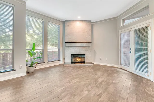 a view of an empty room with a fireplace and a window