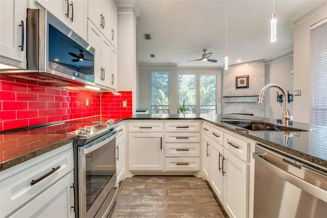 a kitchen with granite countertop a sink and cabinets