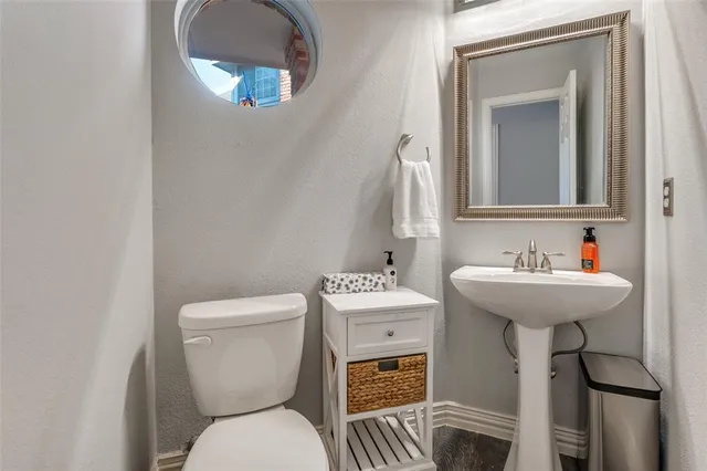 a bathroom with a toilet sink and mirror