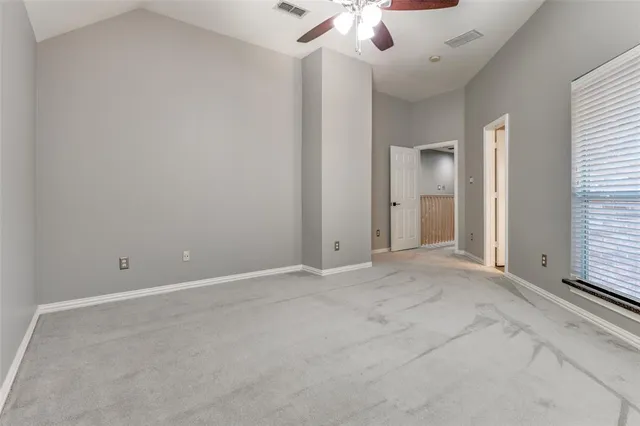 an empty room with a empty space and chandelier fan