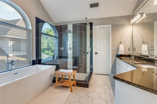 a bathroom with a tub sink and mirror