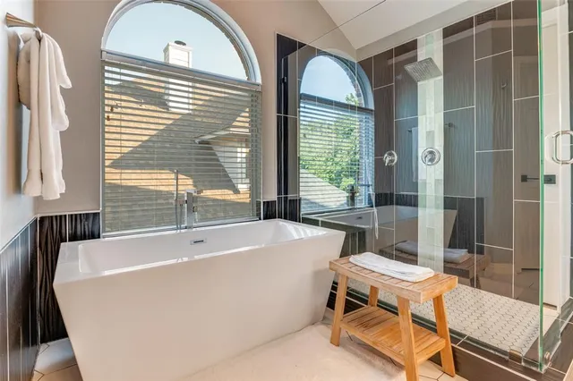 a bath tub sitting next to a bathroom sink