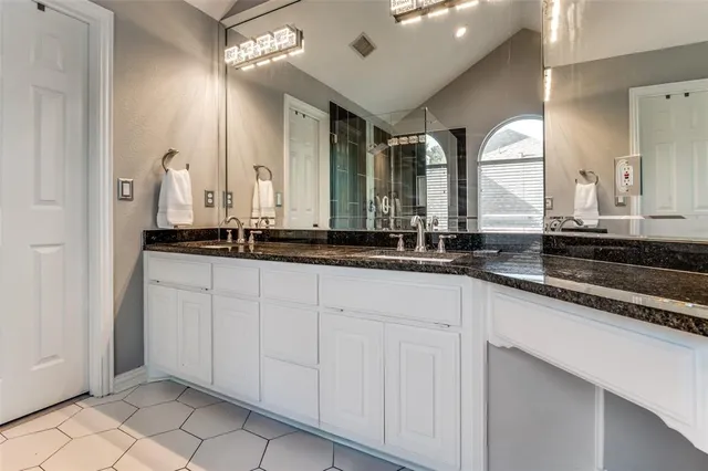 a bathroom with a double vanity sink and a mirror