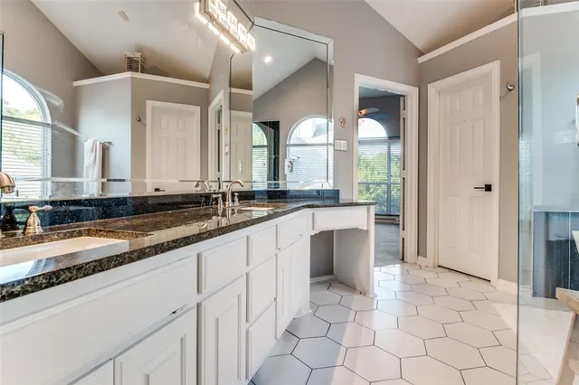 a bathroom with a sink a vanity and a mirror