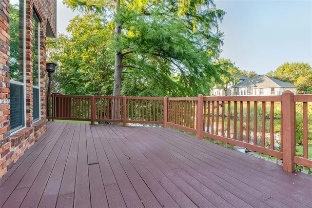 a view of backyard with a deck and wooden floor