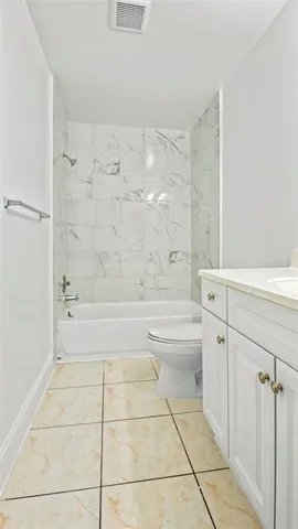 a bathroom with a bathtub and toilet