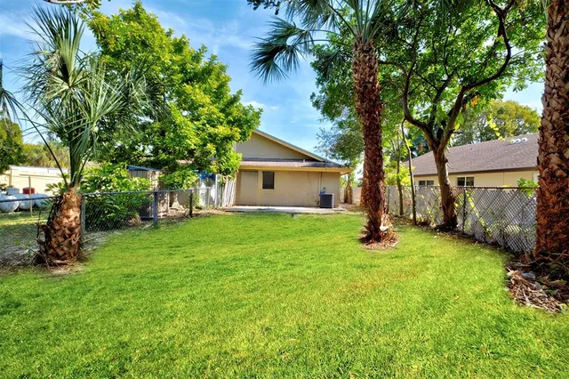 a view of a house with a backyard