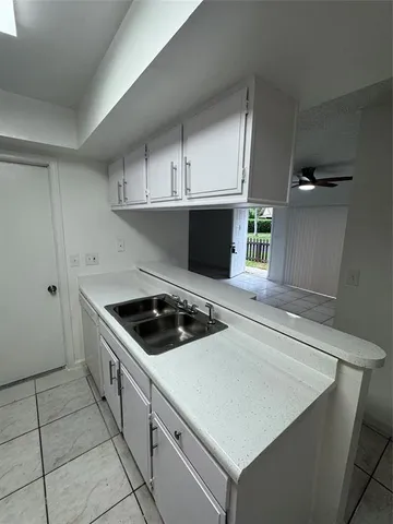 a kitchen with cabinets and white appliances