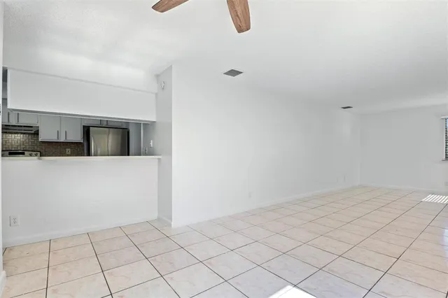 a view of a kitchen with white cabinets