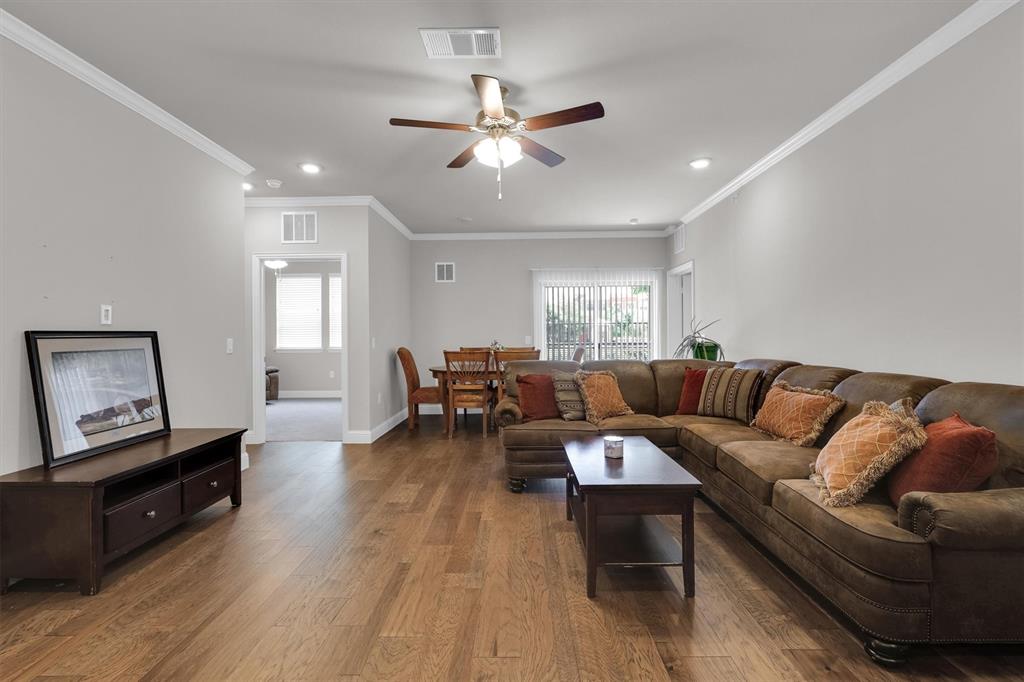 651 Watters Road, Unit 2105 Allen, TX 75013 - Photo 7 of 32 a living room with furniture and a wooden floor