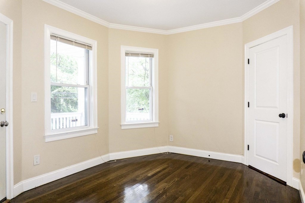 39 Glen Road Boston, MA 02130 - Photo 11 of 15 an empty room with wooden floor and windows