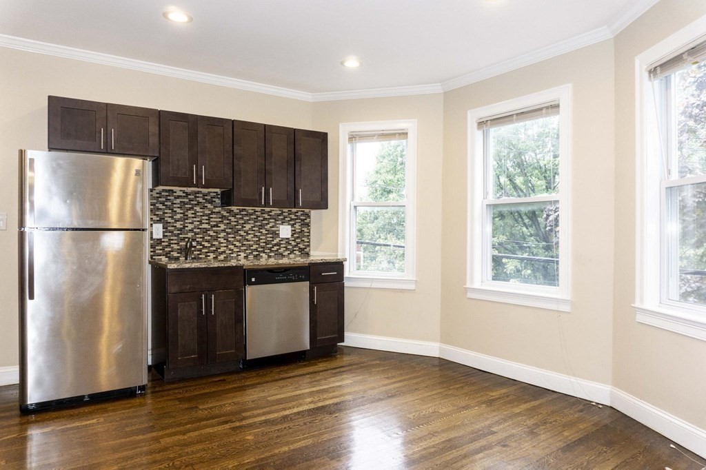 39 Glen Road Boston, MA 02130 - Photo 3 of 15 a kitchen with stainless steel appliances granite countertop a refrigerator and a sink