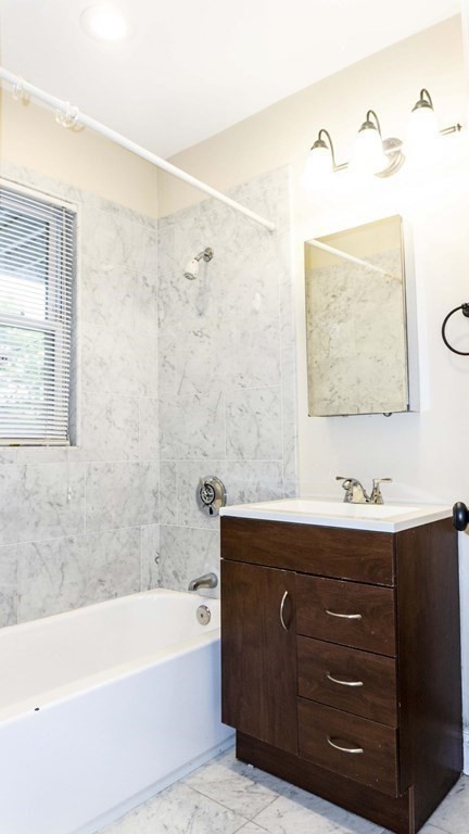 39 Glen Road Boston, MA 02130 - Photo 6 of 15 a bathroom with a bathtub sink vanity and mirror