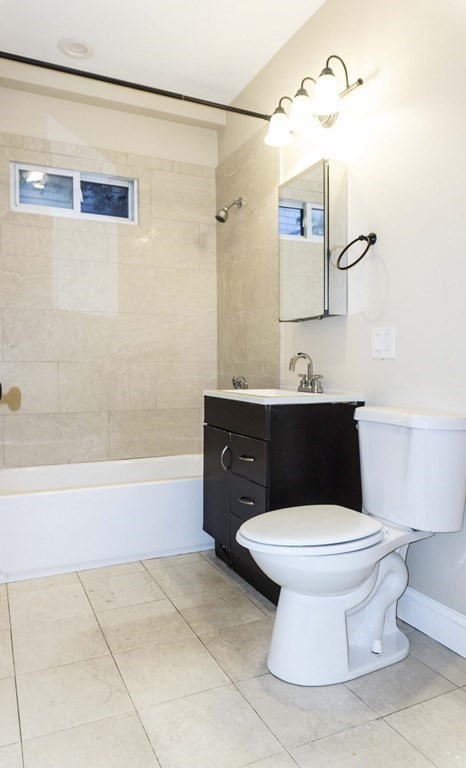39 Glen Road Boston, MA 02130 - Photo 7 of 15 a bathroom with a toilet sink and mirror