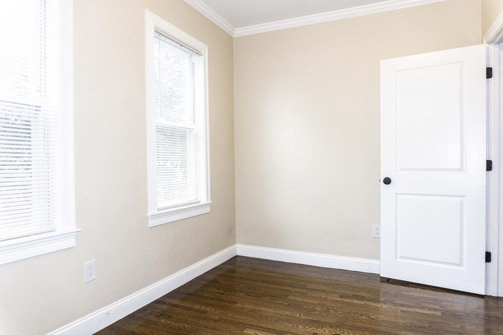 39 Glen Road Boston, MA 02130 - Photo 8 of 15 an empty room with wooden floor and windows