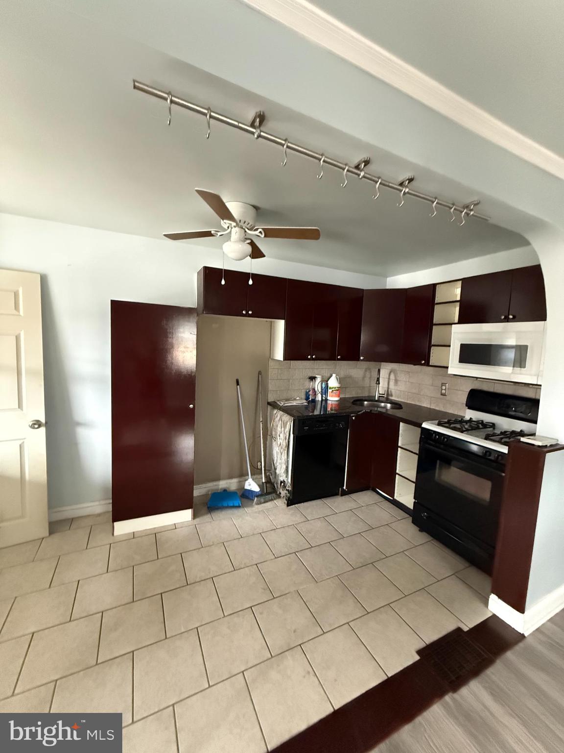 1841 South 28th Street Philadelphia, PA 19145 - Photo 4 of 9 a kitchen with stainless steel appliances granite countertop a sink and a stove