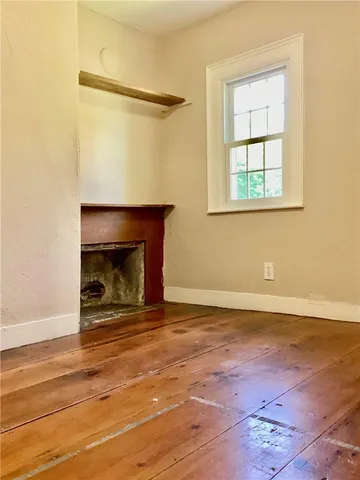 an entryway of a room with wooden floor