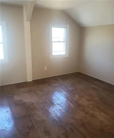 an empty room with wooden floor