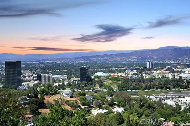 a view of a city with mountains in the background