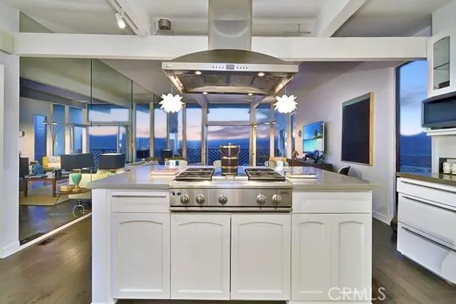 a kitchen with stainless steel appliances granite countertop a stove and cabinets