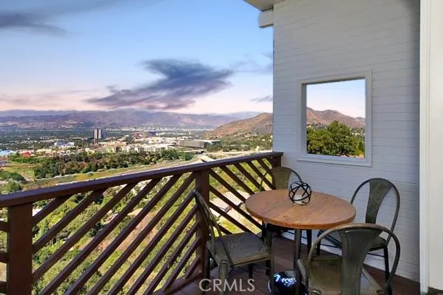 a view of a balcony with chairs