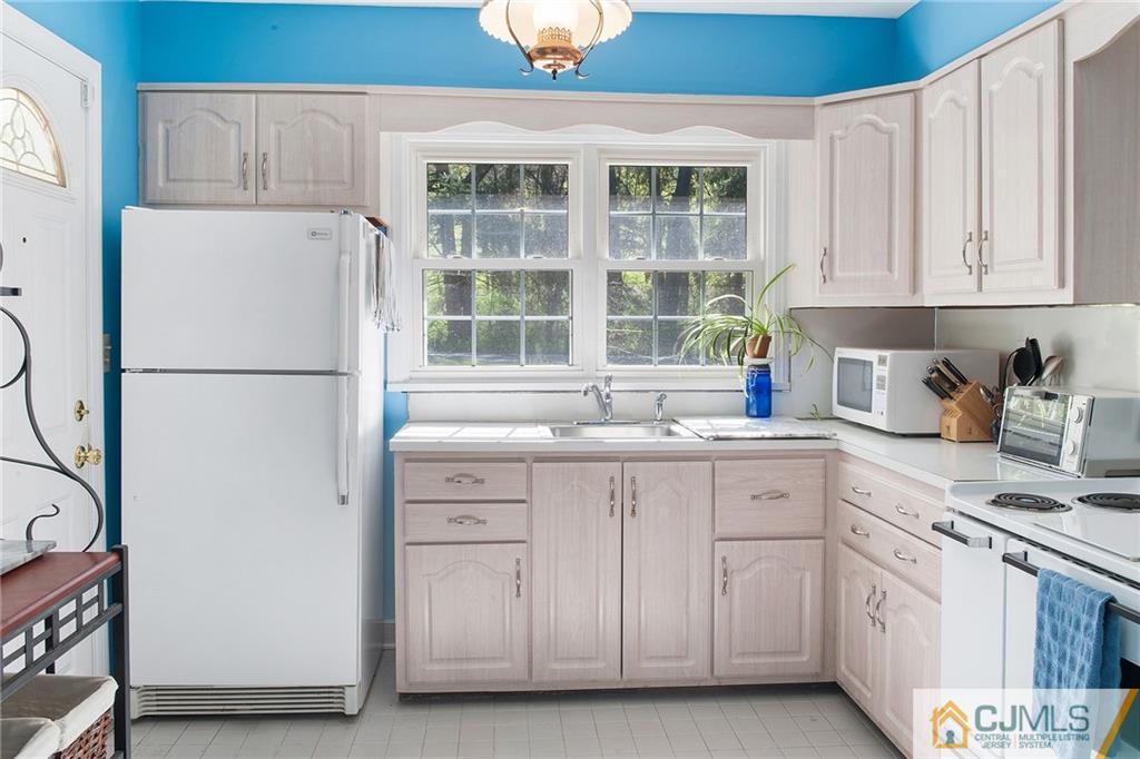 11 Mendham Road Far Hills, NJ 07931 - Photo 8 of 20 a kitchen with white cabinets and white appliances