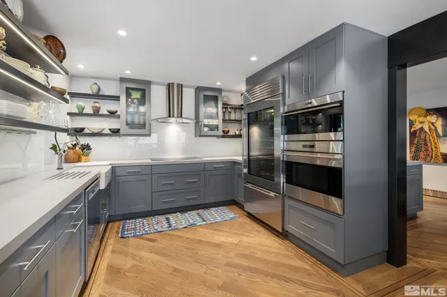 a kitchen with stainless steel appliances granite countertop a sink and cabinets