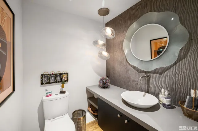 a view of a hallway with wooden floor and stairs