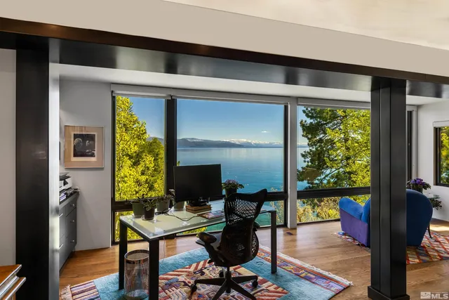 a living room with furniture floor to ceiling window and wooden floor