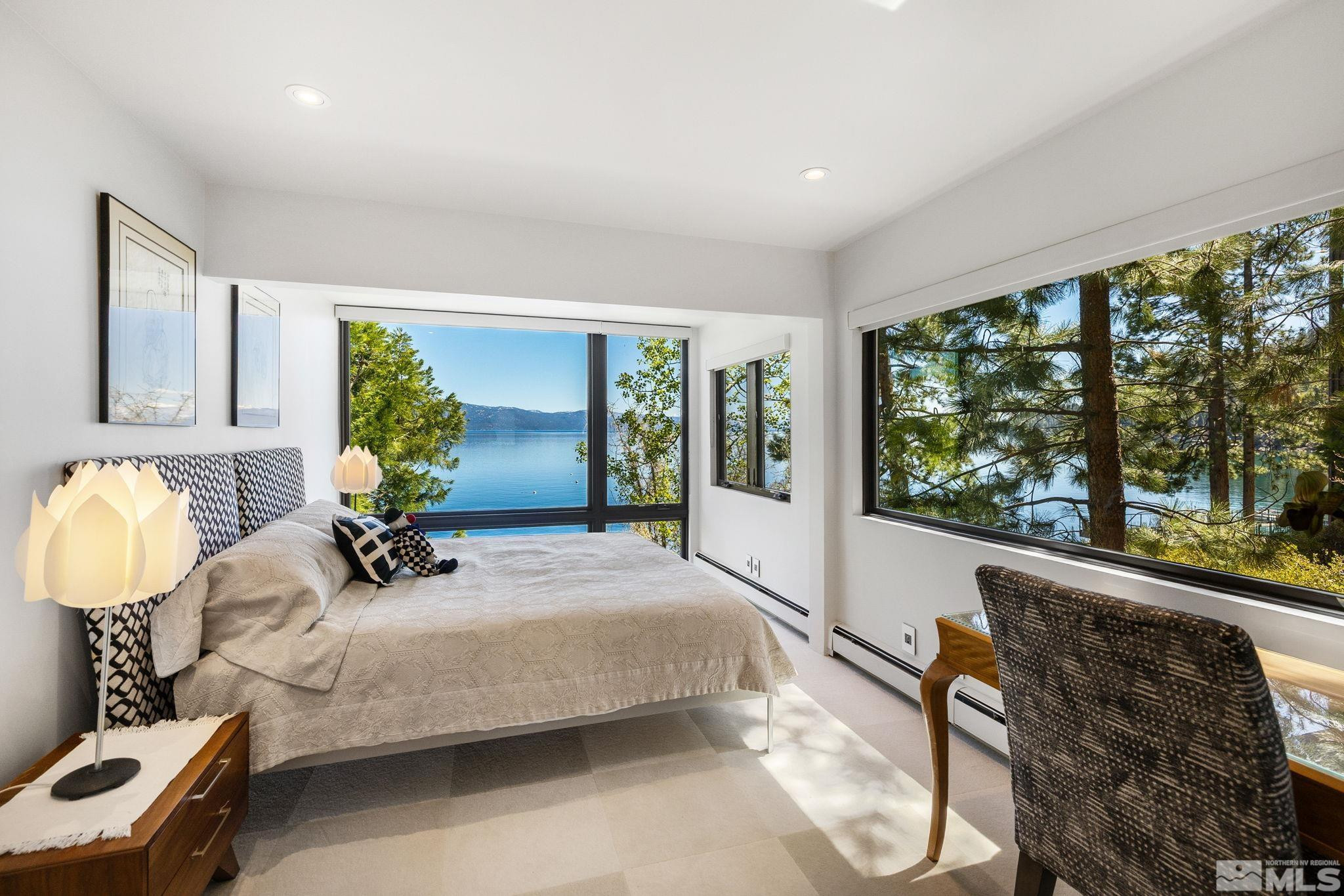 475 Lakeshore Boulevard, Unit 36 Incline Village, NV 89451 - Photo 29 of 40 a bedroom with a bed and large windows