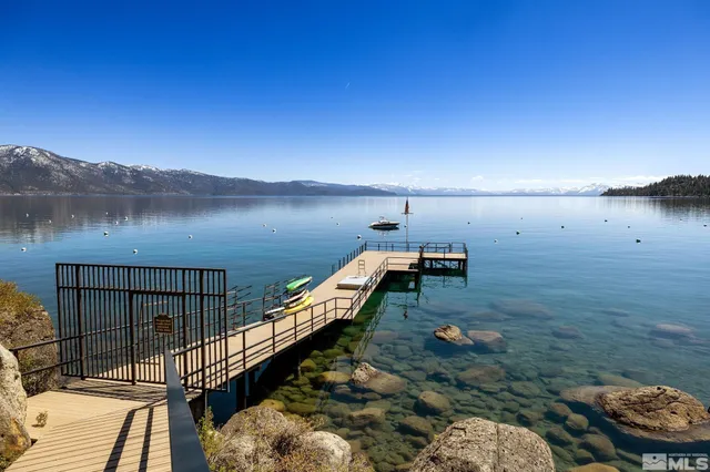 a view of a balcony with wooden floor and lake view