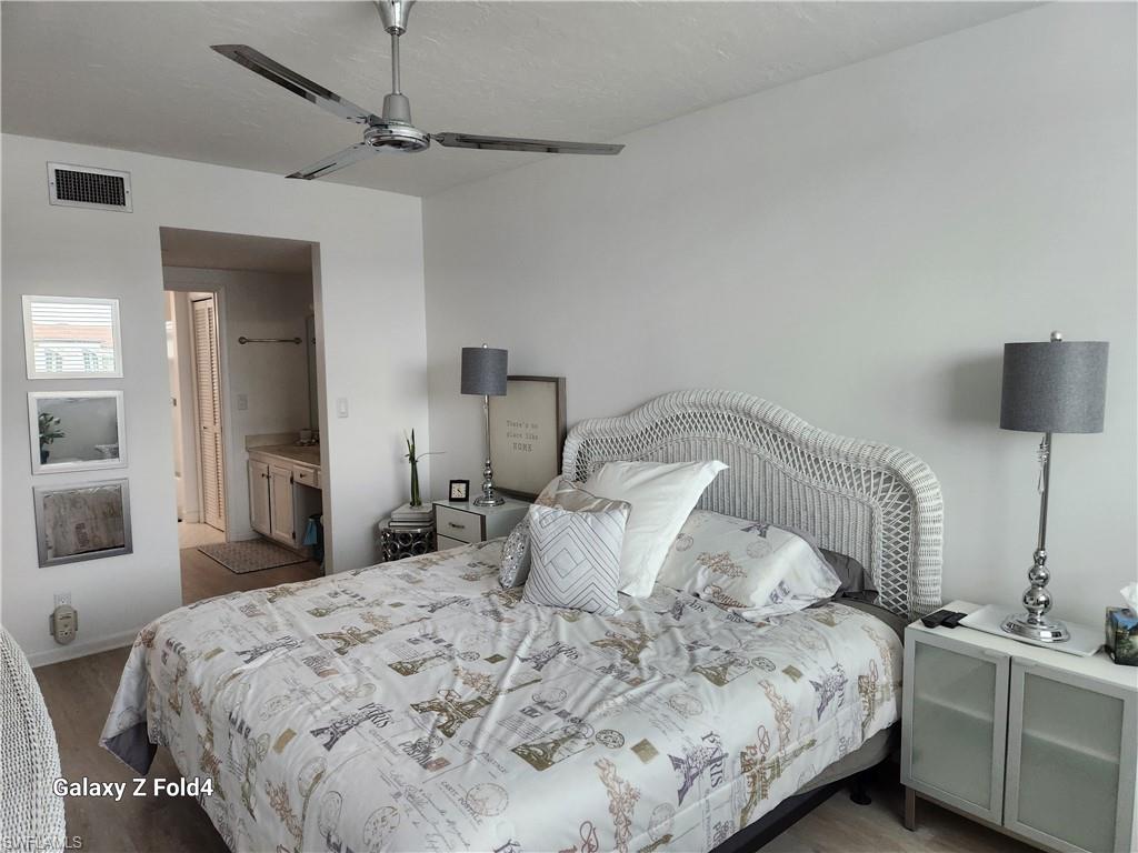 805 River Point Drive, Unit C307 Naples, FL 34102 - Photo 2 of 11 a bedroom with a bed and a lamp