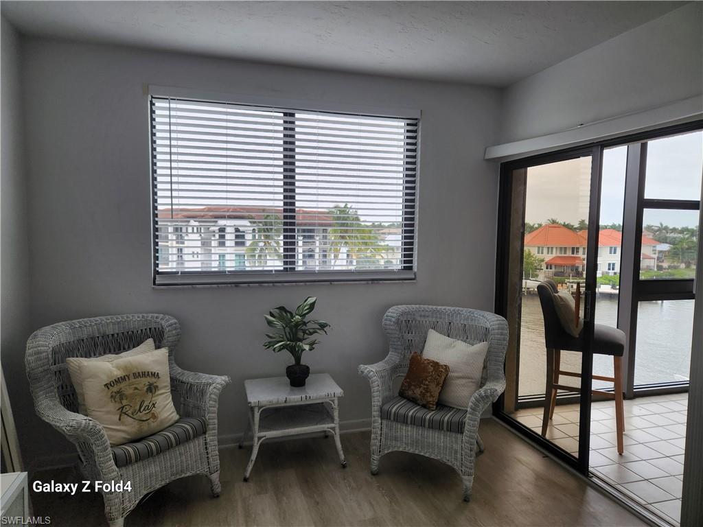 805 River Point Drive, Unit C307 Naples, FL 34102 - Photo 8 of 11 a living room with furniture and a window