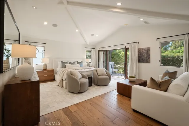 a view of a balcony with wooden floor and outdoor seating
