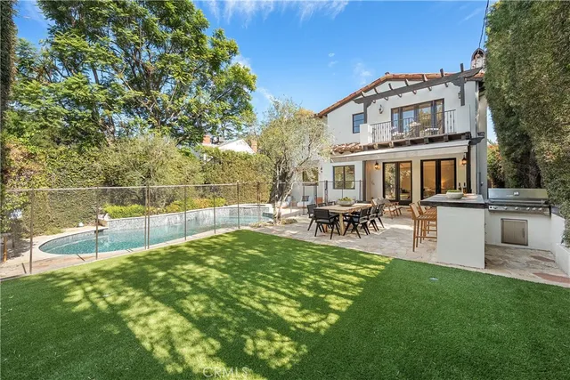 a view of a house with a yard patio and sitting area