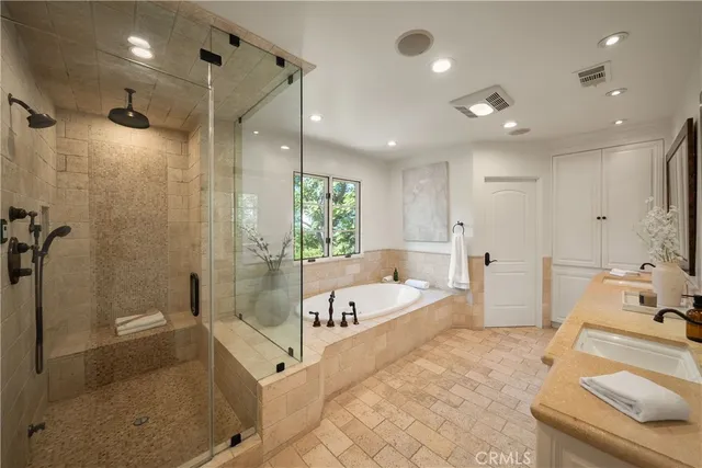 a bathroom with double sink and a mirror