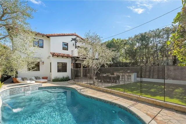 a view of a patio with table and chairs potted plants and large tree